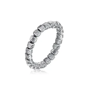 Close-up detail of silver stainless steel elastic ring with diagonal textured beads.