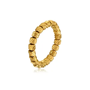 Macro view of the textured golden beads on a durable stainless steel stretch ring