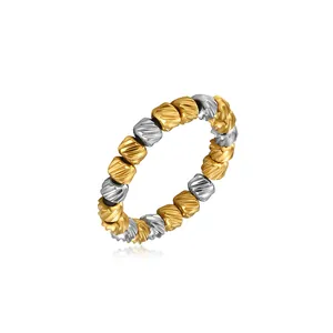 Close-up of a two-tone stainless steel elastic ring with diagonal stripe beads