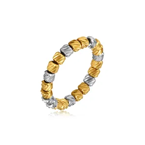 Detailed view of two-tone stainless steel stretch ring with textured diagonal beads.