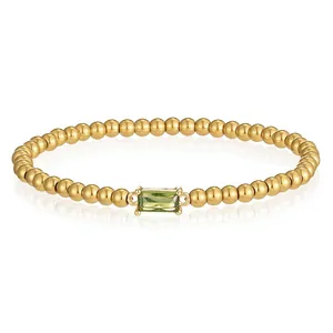 Detail eines goldenen Perlenarmbands mit einem smaragdgeschliffenen grünen Zirkonia-Stein
