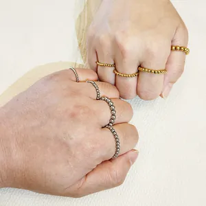 Vista detallada de anillos elásticos de cuentas de acero de titanio oro y plata