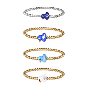 Detail view of four colorful ceramic duck beaded elastic bracelets in gold and silver