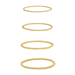 Detail of four 18K gold plated stainless steel elastic beaded bracelets in various sizes