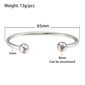 Stainless steel cuff bracelet detail showing 65mm diameter and unscrewable ball heads.