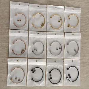 Detailed view showing twelve stainless steel ball-end cuff bracelets in individual poly bags
