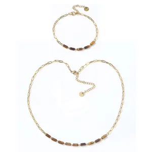 Elegant gold stainless steel necklace and bracelet set featuring tiger eye tube beads