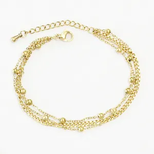 Detailed view of the triple-layered gold-plated stainless steel bead chain anklet with lobster clasp