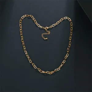 Detailweergave van een duurzame gouden roestvrijstalen schakelketting op een donkere achtergrond.
