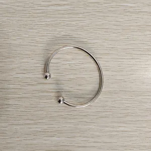 Detail view of stainless steel open bangle with removable screw-on ball ends for DIY