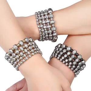 Detail view of textured stainless steel elastic bracelets with shiny grid bead patterns