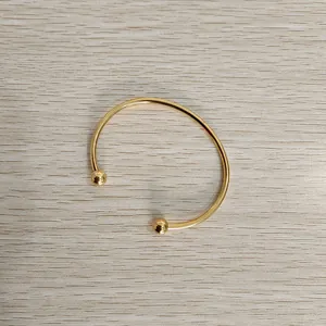 Elegant minimalist gold-plated stainless steel cuff bracelet with ball end detail