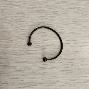 Close-up of black titanium steel open cuff bracelet with removable screw-ball heads