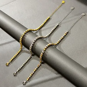Nahaufnahme von drei strukturierten Edelstahl-Perlenarmbändern in Gold- und Silberoptik.