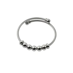 Adjustable silver stainless steel wire cuff bracelet with sliding round beads detail