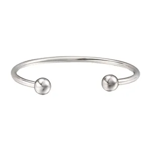 Macro view of polished stainless steel cuff bracelet with detachable ball ends