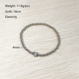 Close-up of a 4mm stainless steel beaded elastic bracelet with a heart S charm.