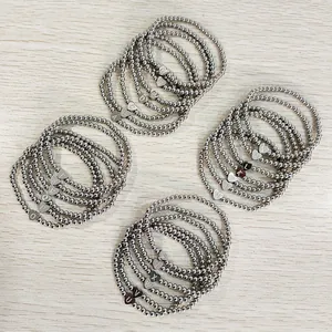 Detailed view of stainless steel beaded heart initial bracelets showing all A-Z letters.
