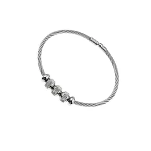 Detailed view of stainless steel wire bracelet with textured beads and silver finish