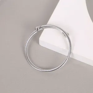 Macro view of silver stainless steel twisted cable cuff bracelet with round ball ends