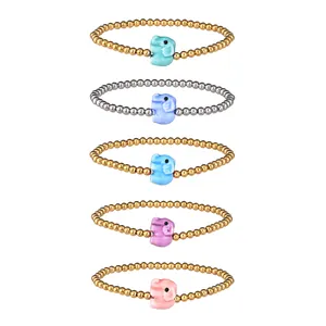 Detail of five stainless steel beaded bracelets with colorful ceramic elephant charms