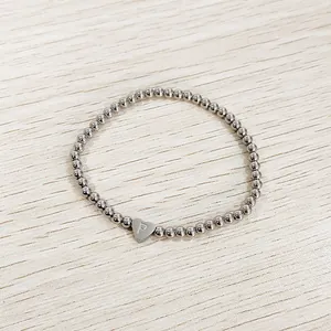 Detail view of silver stainless steel beaded bracelet with engraved heart P charm