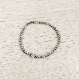 Silver stainless steel beaded elastic bracelet with heart charm featuring letter Q