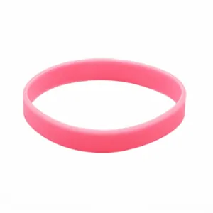 Detail view of a solid pink luminous silicone wristband with a flexible rubber texture
