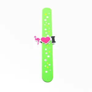 Detailed view of a green silicone slap band featuring flamingo and heart star patterns