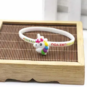 Primo piano di un braccialetto in silicone unicorno bianco con decoro colorato