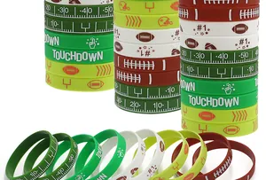 Macro view of colorful football-themed silicone wristbands with various sports motifs