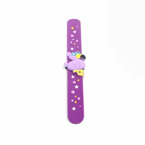Detailed view of a purple silicone slap bracelet with a cartoon flamingo and star patterns