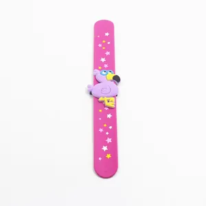 Detailed view of pink silicone flamingo slap bracelet with yellow and white stars.