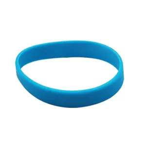 Detail view of a flexible blue silicone luminous wristband on white background