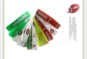 Detailed view of assorted colorful silicone football wristbands with Touchdown and #1 prints.