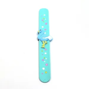 Detailed view of light blue silicone slap bracelet with flamingo and star patterns