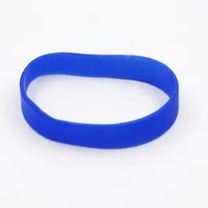 Detailed view of a flexible blue silicone wristband on a plain white background.