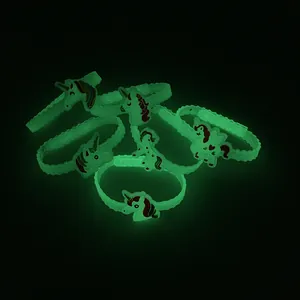 Vista dettagliata che mostra l'effetto luminoso verde dei braccialetti in silicone.