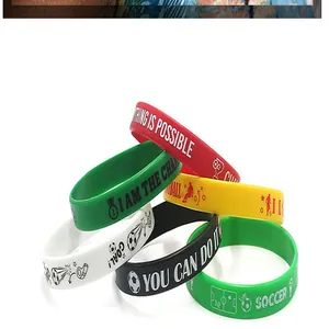 Macro detail of multi-colored silicone soccer wristbands with motivational slogans