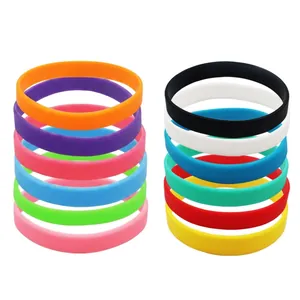 Stacks of colorful silicone wristbands in vibrant neon shades on a white background