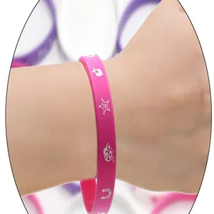 Detail showing pink cowboy girl silicone bracelet with white themed graphics on wrist