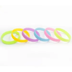Detailed view of multi-colored luminous silicone wristbands in six vibrant neon shades