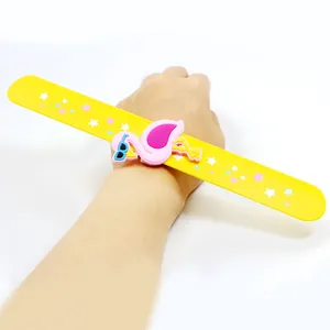 Close-up view of a yellow flamingo slap bracelet featuring star patterns on a wrist