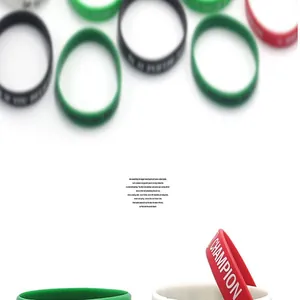 Close-up of various colorful silicone sports wristbands with CHAMPION text print detail