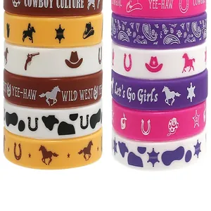 Detailed macro view of colorful cowboy themed silicone wristbands with Western prints and text