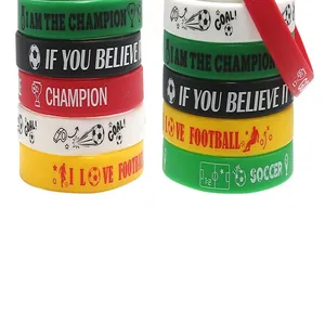 Detailed view of colorful soccer-themed silicone wristbands with motivational quotes