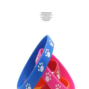Close-up detail of soft silicone wristbands featuring white animal paw prints