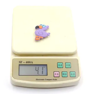Close-up detail showing the light weight of a purple flamingo PVC charm for slap bracelets.