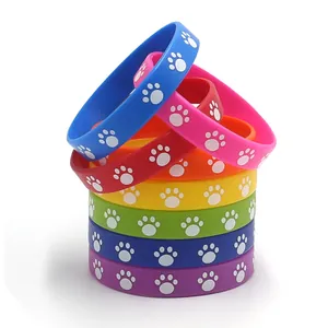 Stack of colorful silicone wristbands featuring white paw prints for animal-themed party gifts