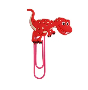 Detail eines Cartoon-Dinosaurier-Lesezeichens aus PVC mit rosa Metallclip